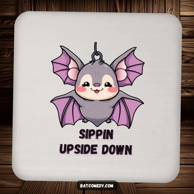 Funny kawaii bat with a silly grin hanging upside down on a drink coaster, offering humorous surface protection.