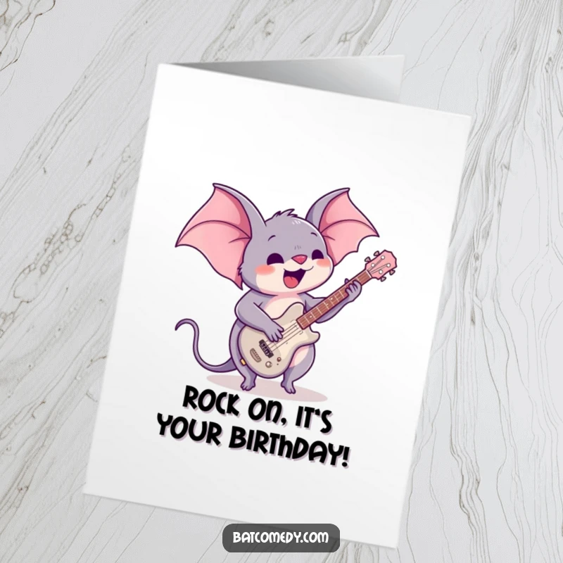 Funny Free Printable Birthday Card: A kawaii bat enthusiastically playing a tiny guitar, ready to rock a birthday bash.